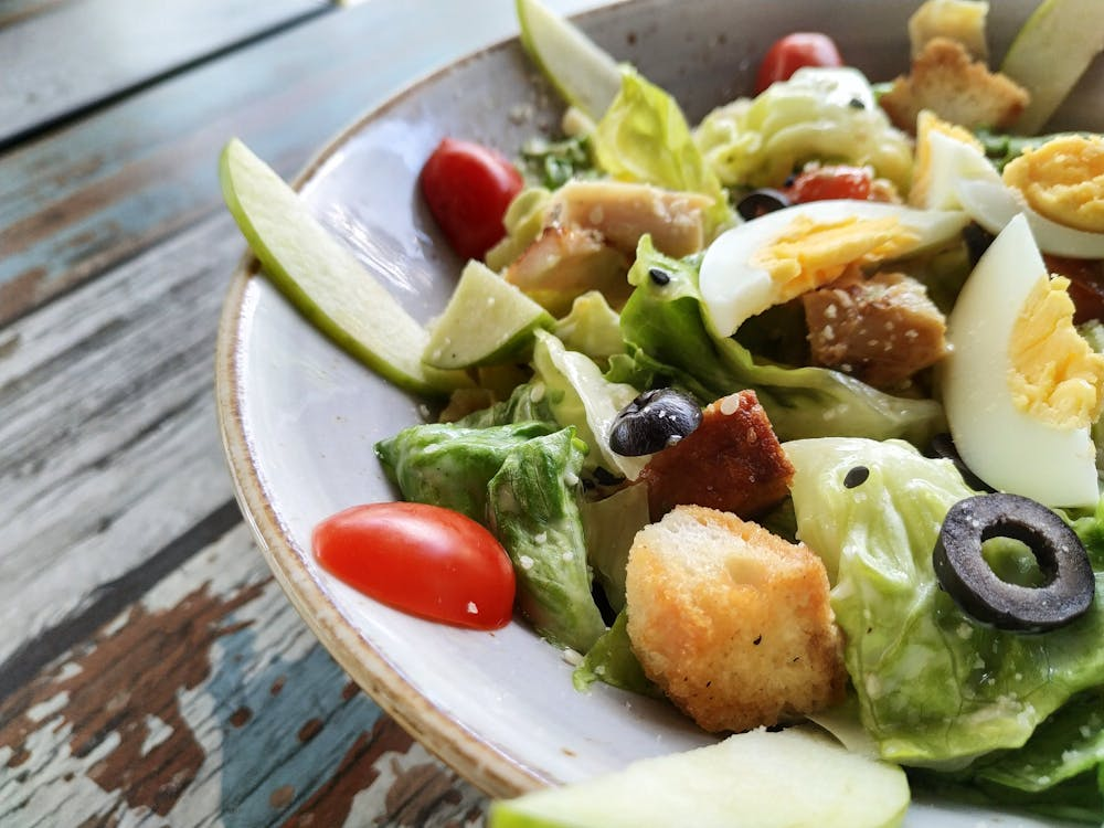 Close-up of a vegetable salad with boiled egg slices.