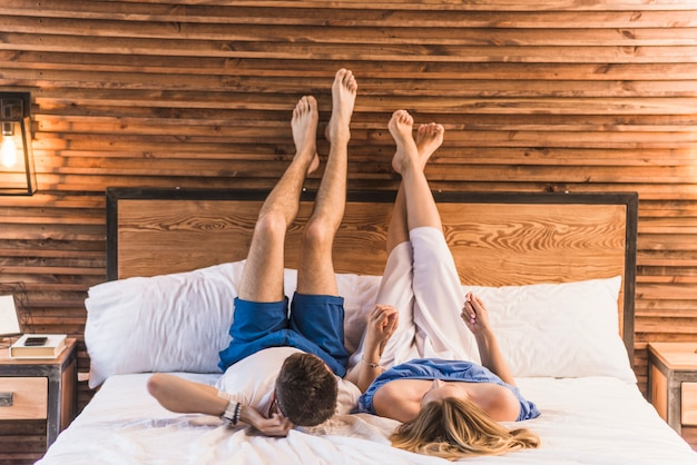 couple holding hands in bed